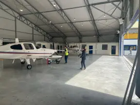 2 aeroplanes inside an aircraft hangar