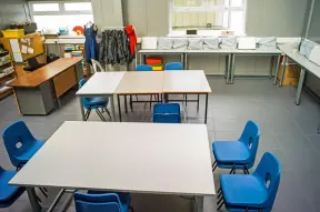 School classroom, tables with blue chairs