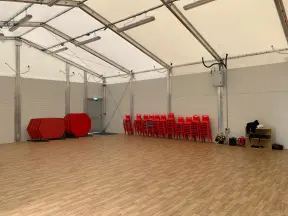 Temporary showroom with red chairs and tables